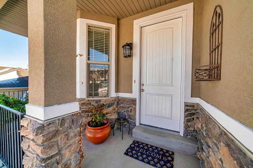 Entry Doors Clearwater FL Front porch of home with single hung window and white front door at the entrance.