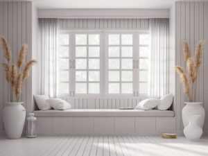 Windows in a white home with white drapes