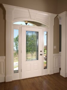 White front door with intricate glass