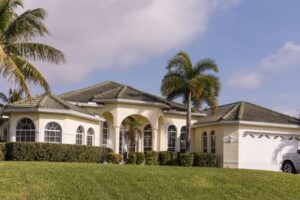 Luxury home in a suburb with palm trees and a large lawn