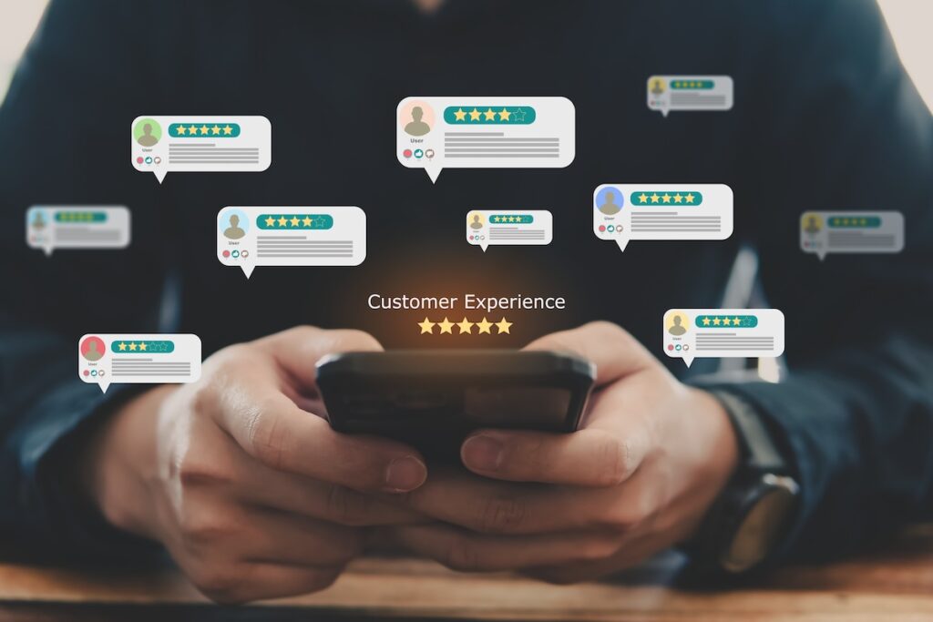 Hand pressing a five-star customer review rating on a digital screen