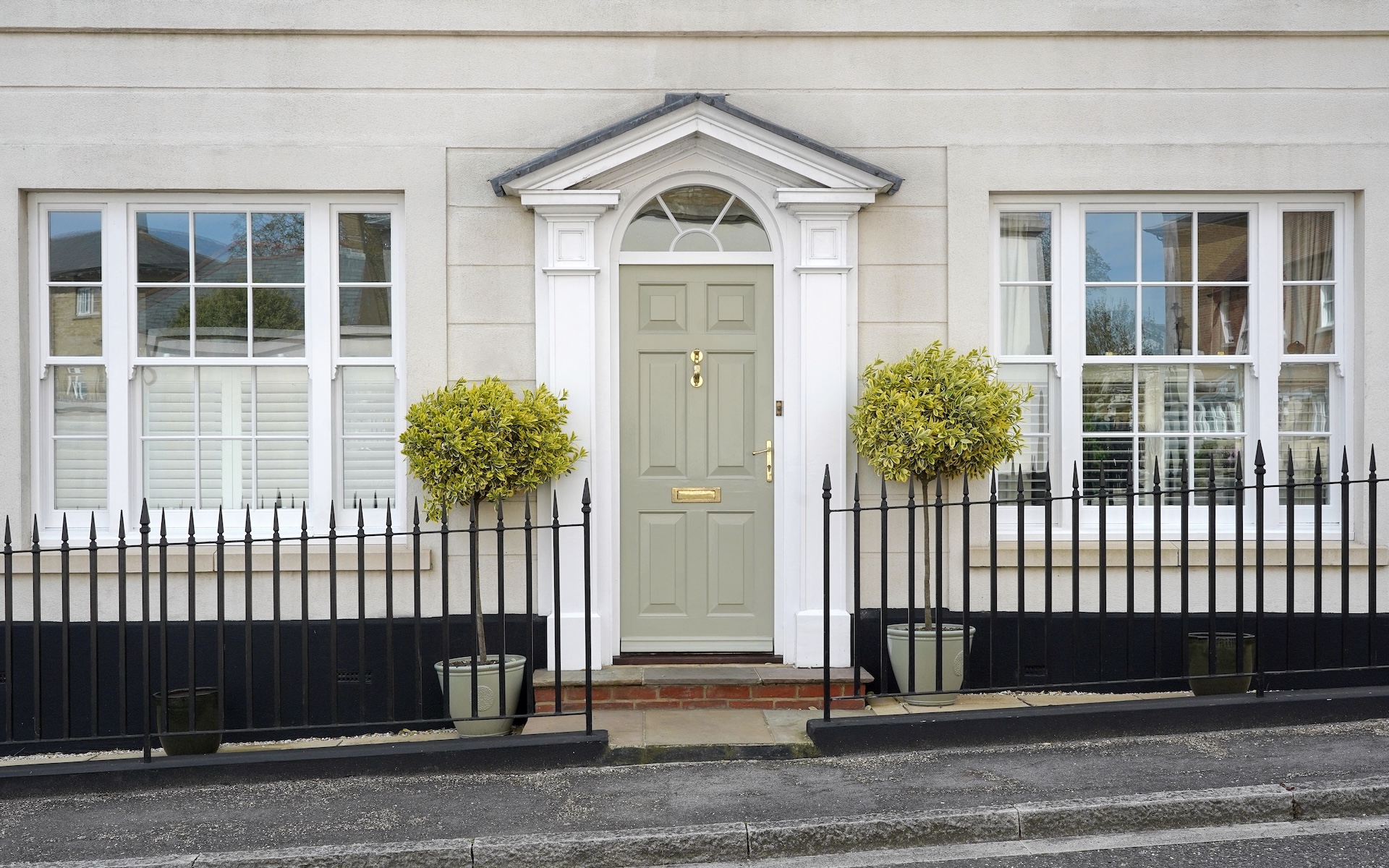 Exterior of a beautiful old town house with windows and front entry details